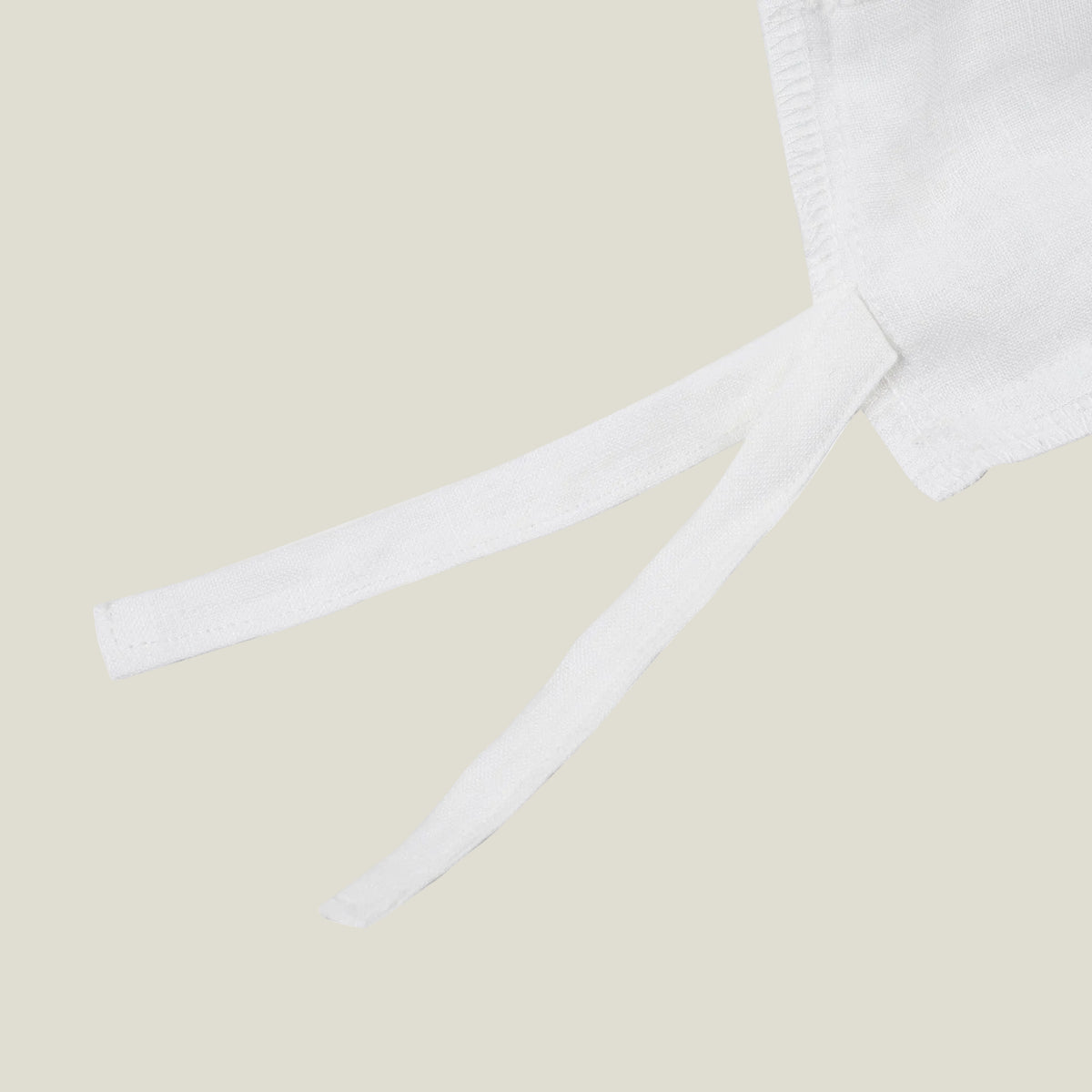 Fabric tie detail on the soft white natural linen duvet cover