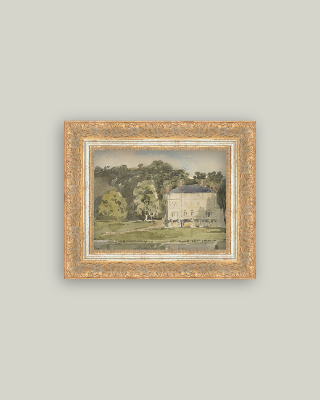 The Chateau View landscape art print of a pale chateau among green trees in an ornate gold frame, hung on a soft grey wall