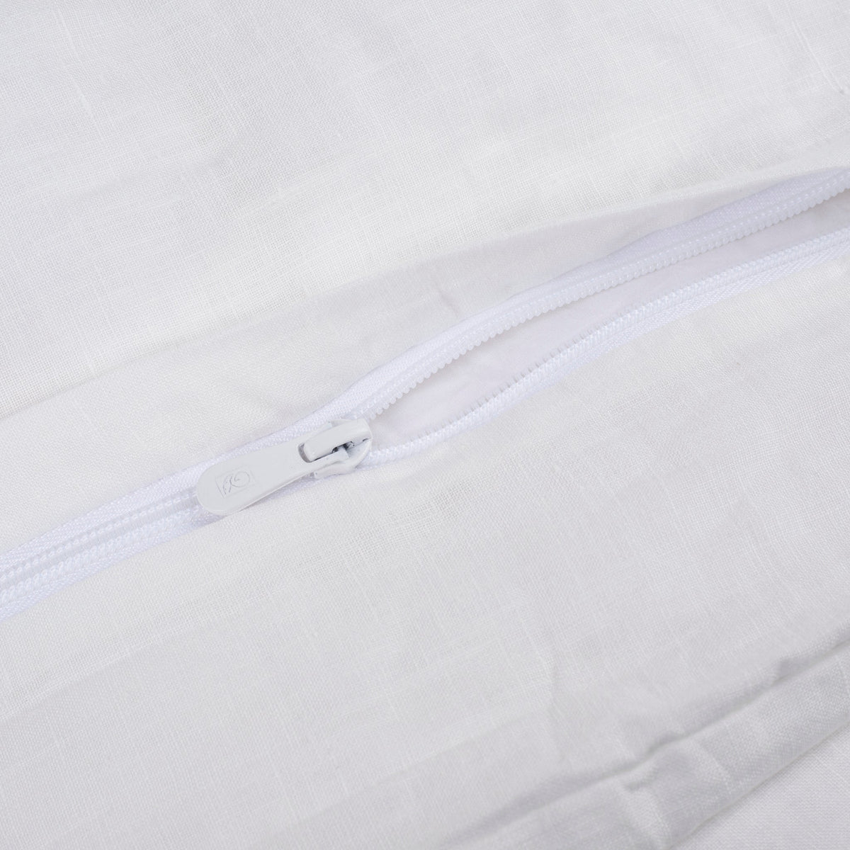 Zipper closure detail on the soft white natural linen duvet cover