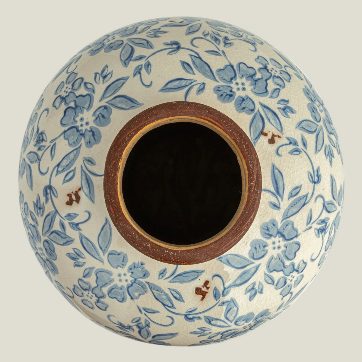 Top view of the blue and cream transferware terra-cotta vase showing its opening and floral pattern