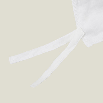 Fabric tie detail on the soft white natural linen duvet cover