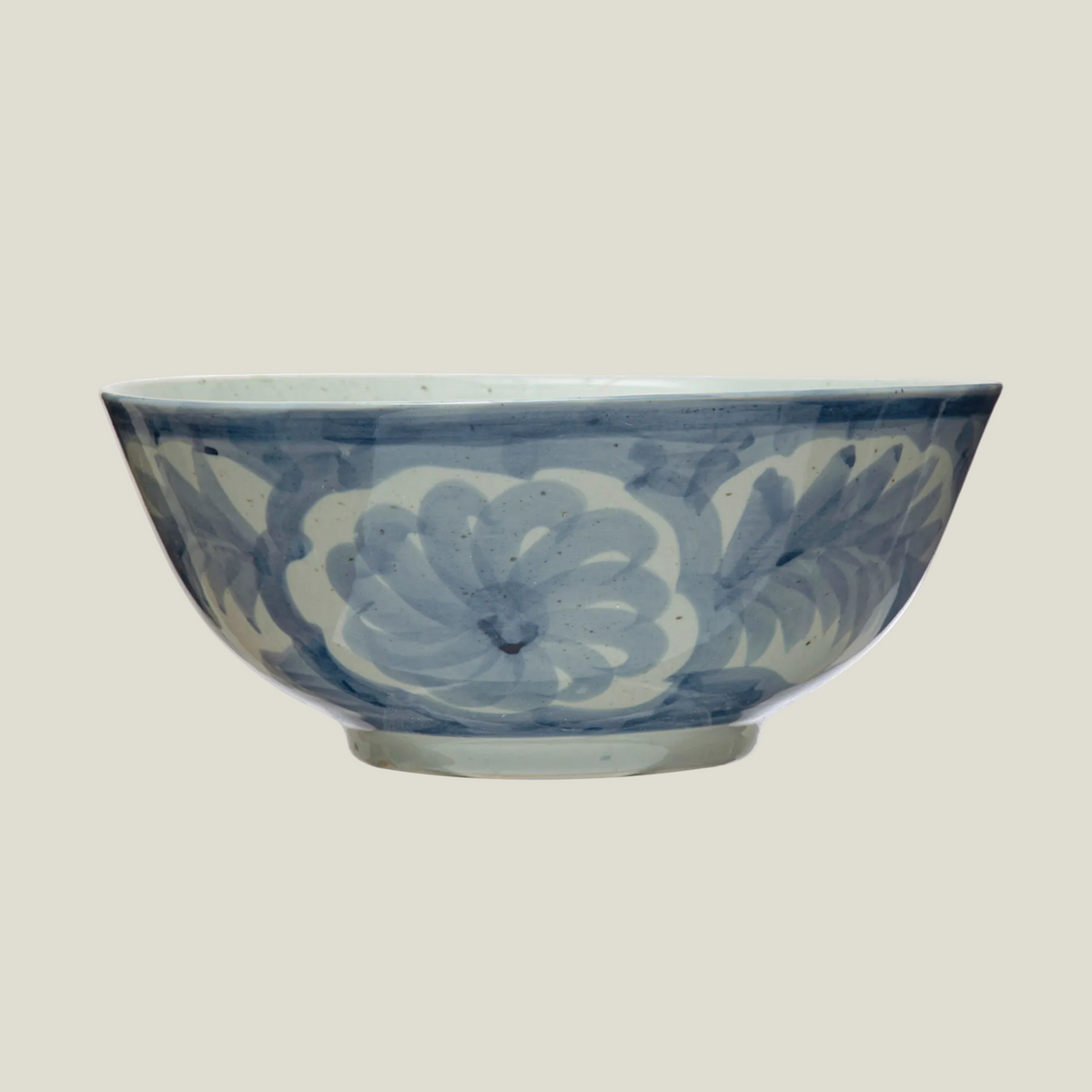 The Hampton Bloom Bowl, a 14 inch stoneware bowl hand-painted with large soft blue florals on white, shown from the side