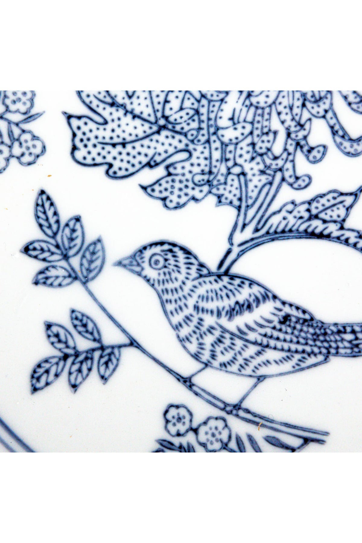 Close-up of the hand-drawn cobalt blue bird and leaf pattern on the Delft Garden Bowl