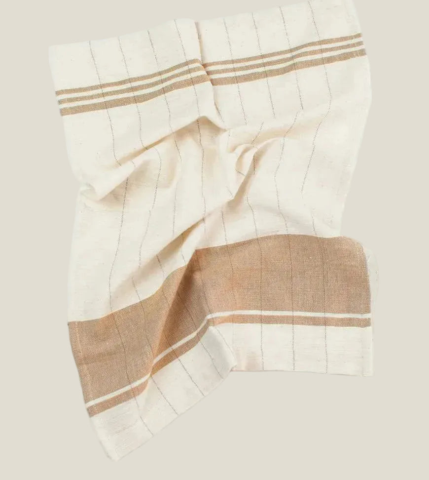 The Chelsea tea towel in ivory with fine pinstripes and a beige stripe band, laid flat