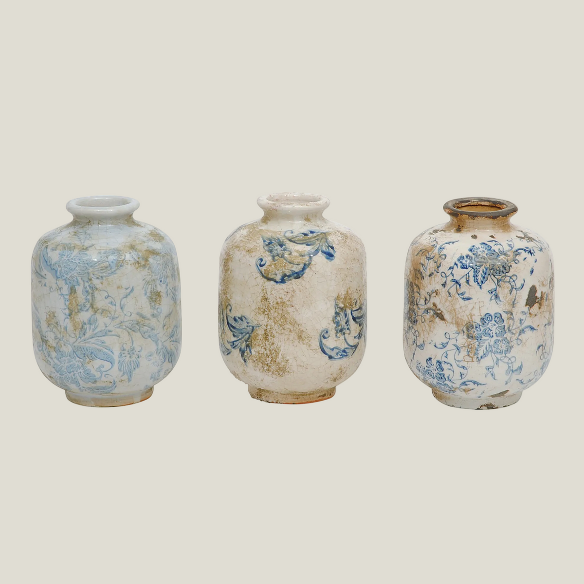 Set of 3 small terra-cotta vases in cream with blue and soft green-blue patterns, front view