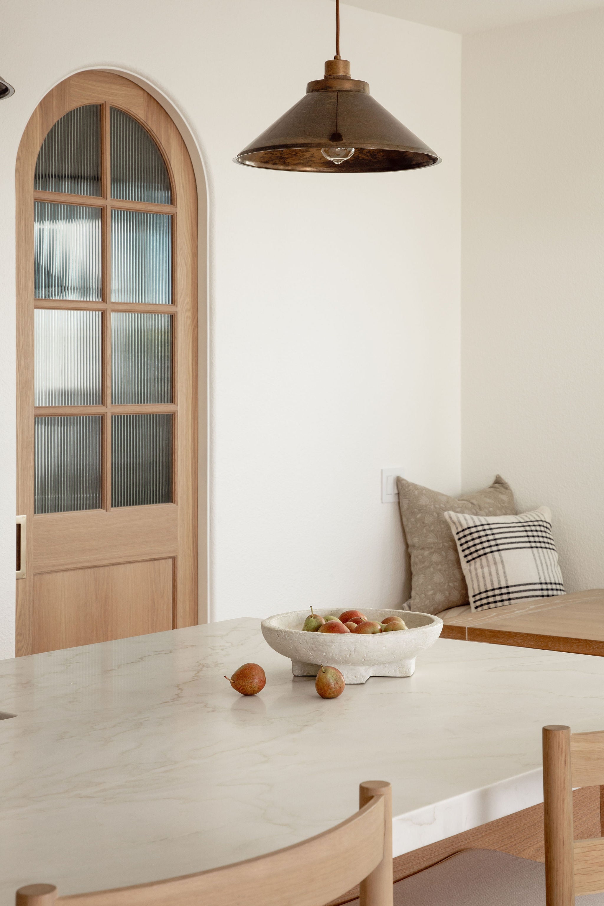 Soft florals in a white glazed pot styled on Calacatta Lux Quartzite kitchen counter