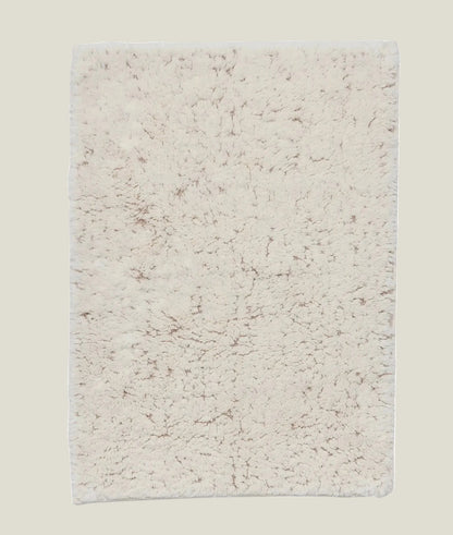 Top-down view of the Elsa 30 x 20 inch off-white cotton and linen bath mat