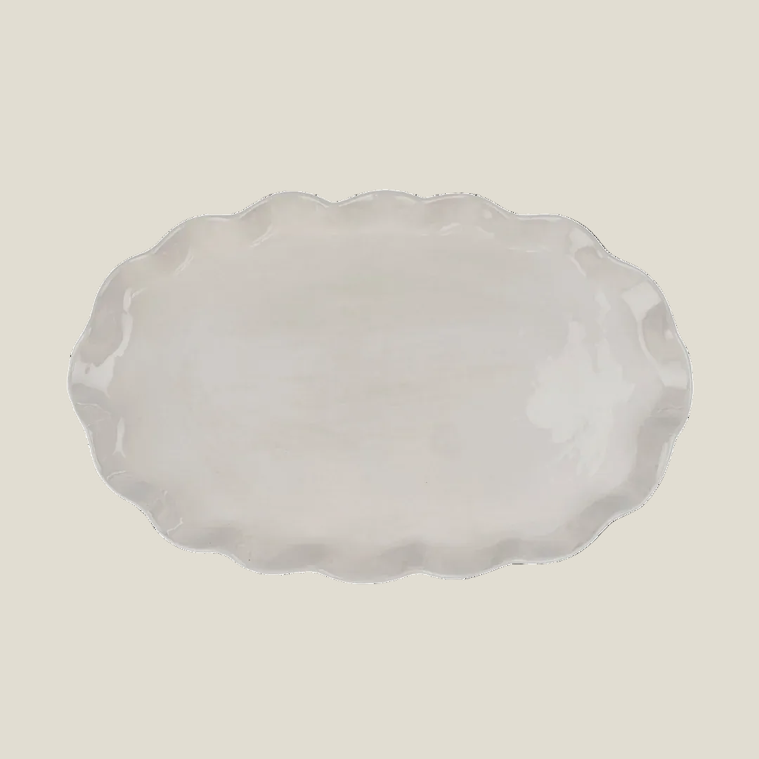 The Calypso scalloped oval platter in creamy white