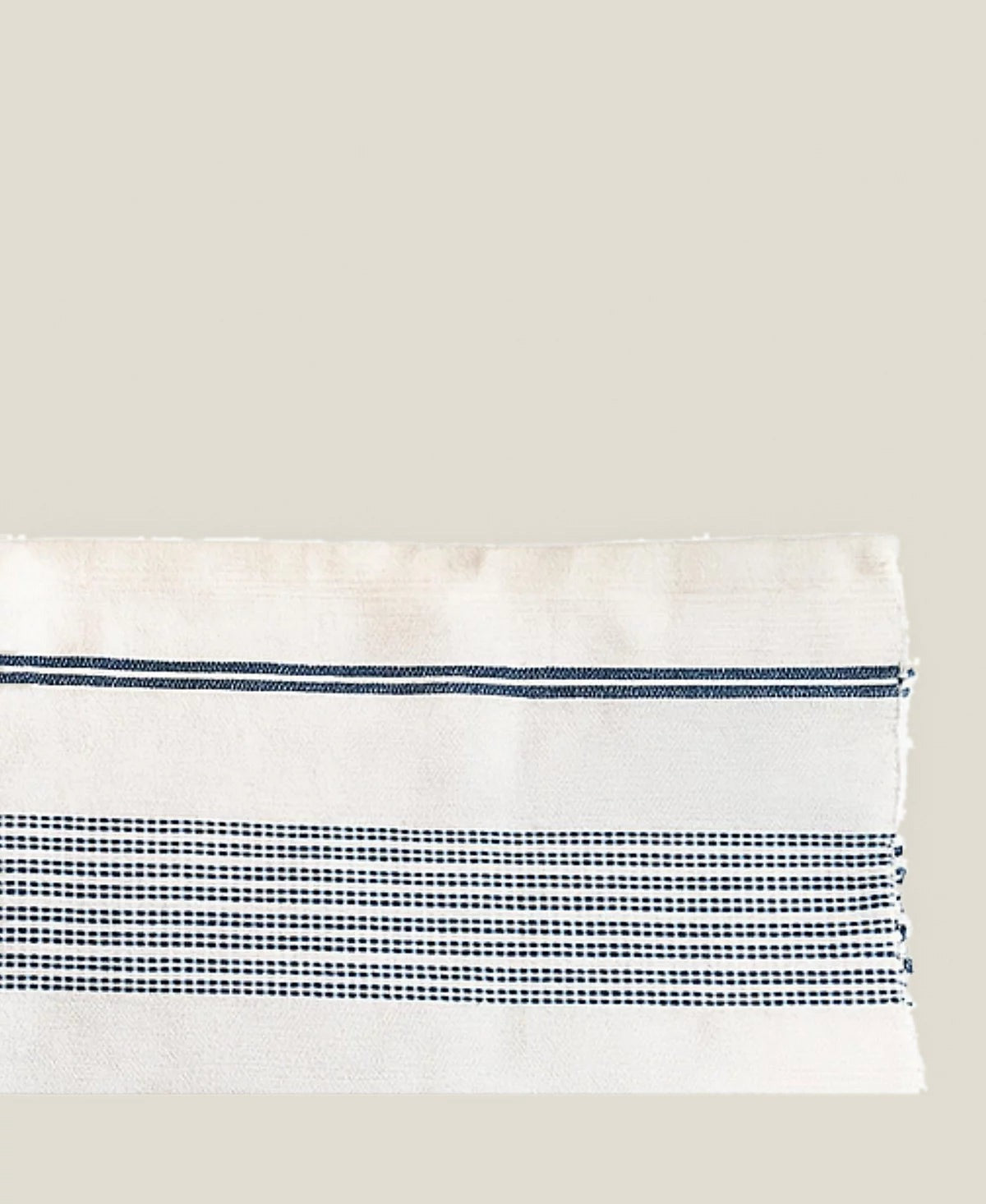 Close-up of the Aden bath mat's natural ground and stripe bands