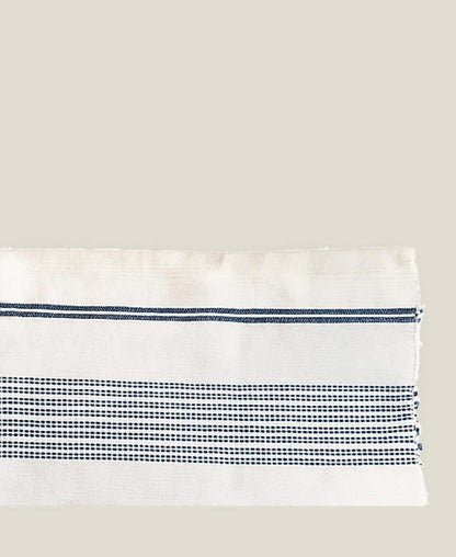 Close-up of the Aden bath mat's natural ground and stripe bands