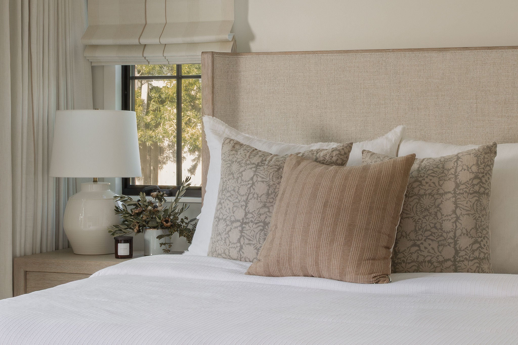 Primary bedroom in layered linen with soft garden light in the Dover Shores whole-home renovation, Newport Beach, California — Joey Snow Design Co.