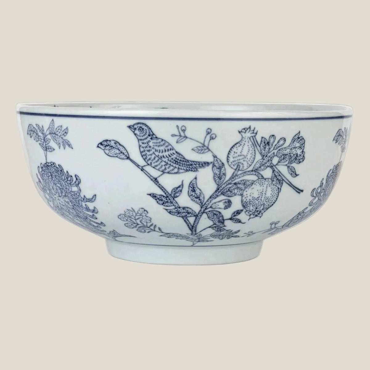 The Delft Garden Bowl, a 10 inch blue and white stoneware bowl with birds and flowers, shown from the side